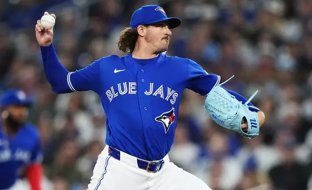 Toronto Blue Jays pitcher Kevin Gausman (34) works against the Los Angeles Dodgers during the first inning of a baseball game in Toronto, Tuesday, April 7, 2026. (Nathan Denette/The Canadian Press via AP)