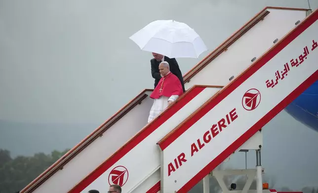 Pope Leo XIV arrives at Algiers' Houari Boumédiène International Airport on Monday, April 13, 2026, at the start of an 11-day apostolic journey to Africa. (AP Photo/Andrew Medichini)