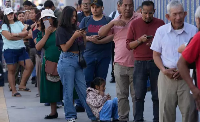 Voters line up at a polling station during general elections in Lima, Peru, Sunday, April 12, 2026. (AP Photo/Martin Mejia)