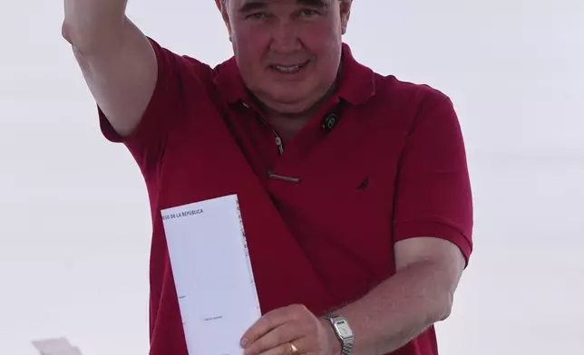Rafael Lopez Aliaga, presidential candidate of the Popular Renewal, votes during general elections in Lima, Peru, Sunday, April 12, 2026. (AP Photo/Guadalupe Pardo)