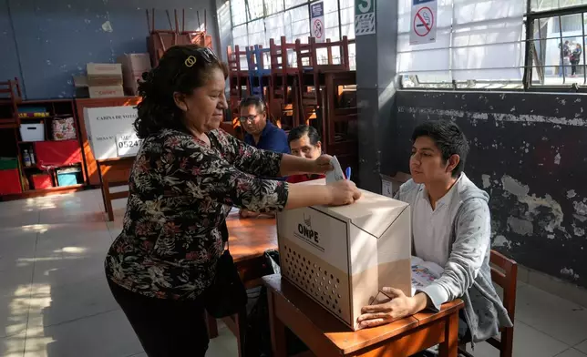 A voter casts a ballot during general elections in Lima, Peru, Sunday, April 12, 2026. (AP Photo/Martin Mejia)