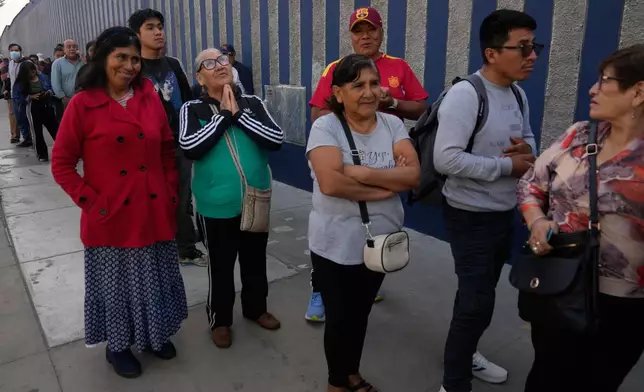 Voters line up at a polling station during general elections in Lima, Peru, Sunday, April 12, 2026. (AP Photo/Martin Mejia)