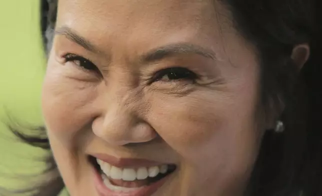 Keiko Fujimori, presidential candidate of the Popular Force party, smiles during a visit to the grave of her father, former President Alberto Fujimori, on the day of general elections in Lima, Peru, on Sunday, April 12, 2026. (AP Photo/Gerardo Marin)