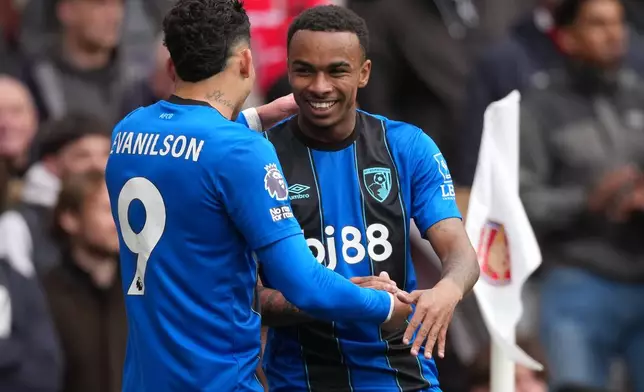 Bournemouth's Evanilson, and Eli Junior Kroupi celebrate after scoring during the Premier League soccer match between Arsenal and Bournemouth in London, England Saturday, April 11, 2026. (AP Photo/Dave Shopland)