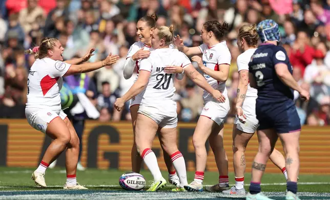 England's Marlie Packer, center, celebrates scoring her side's ninth try of the game, during the Women's Six Nations rugby match between Scotland and England in Edinburgh, Scotland, Saturday April 18, 2026. (Ewan Bootman/PA via AP)