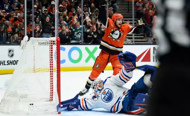 Anaheim Ducks center Tim Washe, top, reacts on goal by left wing Jeffrey Viel during the third period of Game 4 in the first round of an NHL hockey Stanley Cup playoff series against the Edmonton Oilers, Sunday, April 26, 2026, in Anaheim, Calif. (AP Photo/Kyusung Gong)