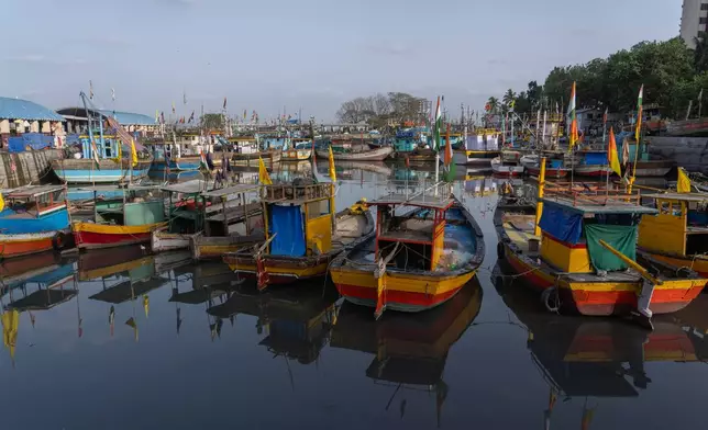Small fishing boats are seen anchored at Sassoon Dock in Mumbai, India, Tuesday, April 7, 2026. (AP Photo/Rafiq Maqbool)
