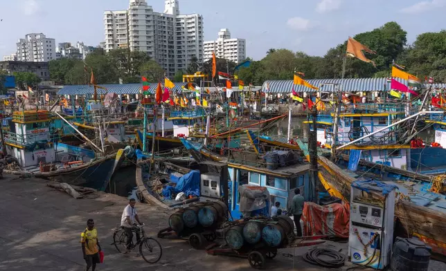 Fishing boats remain anchored at Sassoon Dock beside a cooperative diesel pump that is shut due to rising bulk fuel prices in Mumbai, India, Tuesday, April 7, 2026. (AP Photo/Rafiq Maqbool)