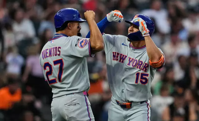 New York Mets' Tyrone Taylor, right, celebrates with Mark Vientos after hitting a three-run home run during the fifth inning of a baseball game against the San Francisco Giants, Saturday, April 4, 2026, in San Francisco. (AP Photo/Godofredo A. Vásquez)