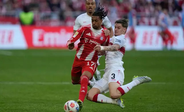 Bayern's Michael Olise, left, and Stuttgart's Ramon Hendriks fight for the ball during a Bundesliga soccer match between Bayern and Stuttgart in Munich, Germany, Sunday, April 19, 2026. (AP Photo/Matthias Schrader)