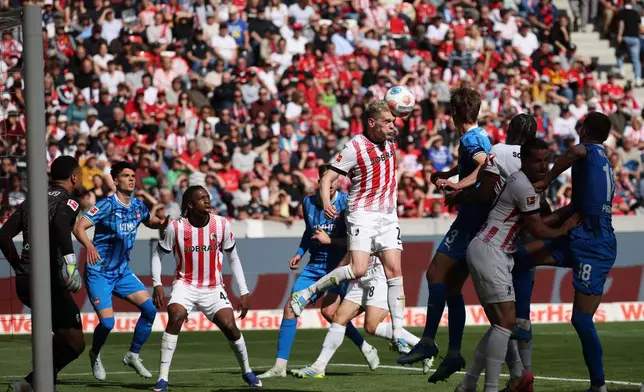 Freiburg's Matthias Ginter with a header during the German Bundesliga soccer match between SC Freiburg and 1. FC Heidenheim in Freiburg, Germany, Sunday April 19, 2026. (Philipp von Ditfurth/dpa via AP)