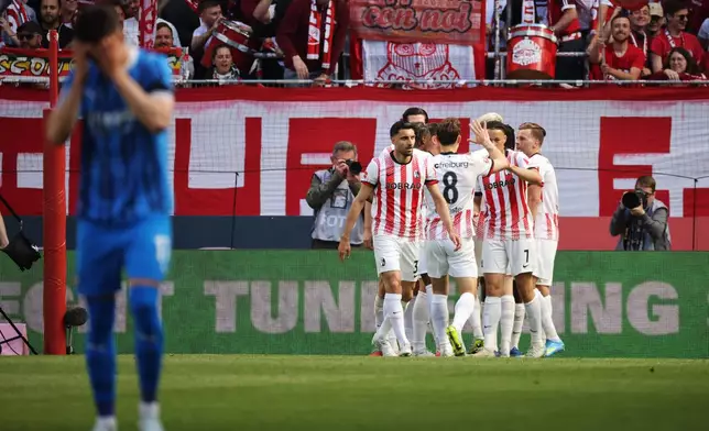 Freiburg's players celebrate Johan Manzambi's first goal of the game during the German Bundesliga soccer match between SC Freiburg and 1. FC Heidenheim in Freiburg, Germany, Sunday April 19, 2026. (Philipp von Ditfurth/dpa via AP)