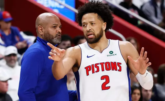 Detroit Pistons guard Cade Cunningham (2) discusses a play with Detroit Pistons head coach J.B. Bickerstaff, left, during the first half in Game 1 against the Orlando Magic in a first-round NBA basketball playoffs series Sunday, April 19, 2026, in Detroit. (AP Photo/Duane Burleson)