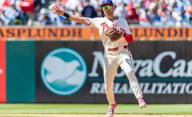 Philadelphia Phillies shortstop Trea Turner throws to first base for an out against Arizona Diamondbacks' Nolan Arenado in the first inning of a baseball game, Sunday, April 12, 2026, in Philadelphia. (AP Photo/Laurence Kesterson)