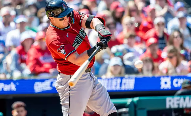 Arizona Diamondbacks' James McCann hits an RBI double in the second inning of a baseball game against the Philadelphia Phillies, Sunday, April 12, 2026, in Philadelphia. (AP Photo/Laurence Kesterson)