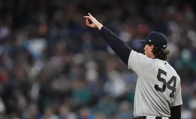 New York Yankees starting pitcher Max Fried reacts after a center fielder Trent Grisham caught a long line drive from Seattle Mariners' Randy Arozarena for an out during the second inning of a baseball game, Tuesday, March 31, 2026, in Seattle. (AP Photo/Lindsey Wasson)