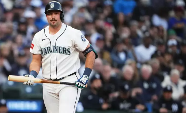 Seattle Mariners' Cal Raleigh walks to the dugout after striking out against the New York Yankees during the first inning of a baseball game, Tuesday, March 31, 2026, in Seattle. (AP Photo/Lindsey Wasson)