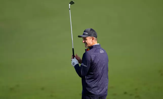 Justin Rose, of England, warms up on the driving range before a practice round at of the Masters golf tournament at the Augusta National Golf Club, Monday, April 6, 2026, in Augusta, Ga. (AP Photo/David J. Phillip)