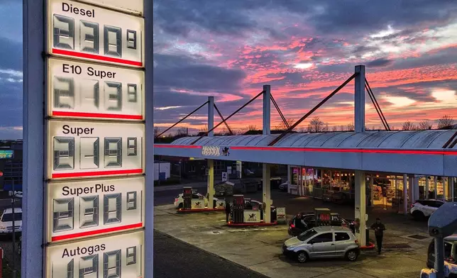 The sun has set behind a gas station in Frankfurt, Germany, Tuesday, March 31, 2026. (AP Photo/Michael Probst)