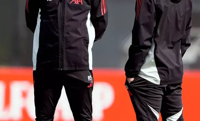 Liverpool manager Arne Slot, left, attends a training session in Liverpool, England, Tuesday April 7, 2026. (Peter Byrne/PA via AP)