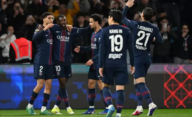 PSG players celebrate after a goal during a League One soccer match between Paris Saint-Germain and Toulouse in Paris, France, Friday, April 3, 2026. (AP Photo/Emma Da Silva)