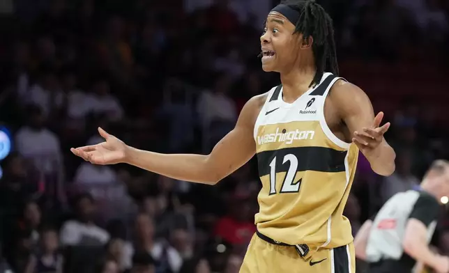 Washington Wizards guard Tre Johnson (12) reacts to a call during the first half of an NBA basketball game against the Miami Heat Saturday, April 4, 2026, in Miami. (AP Photo/Marta Lavandier)