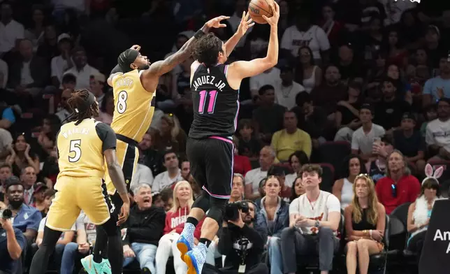 Miami Heat forward Jaime Jaquez Jr. (11) aims to score as Washington Wizards guard Jaden Hardy (8) defends during the first half of an NBA basketball game Saturday, April 4, 2026, in Miami. (AP Photo/Marta Lavandier)