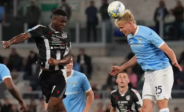 Udinese's Idrissa Gueye, left, and Lazio's Oliver Provstgaard in action during the Serie A soccer match between Lazio and Udinese in Rome, Italy, Monday April 27, 2026. (Alfredo Falcone/LaPresse via AP)
