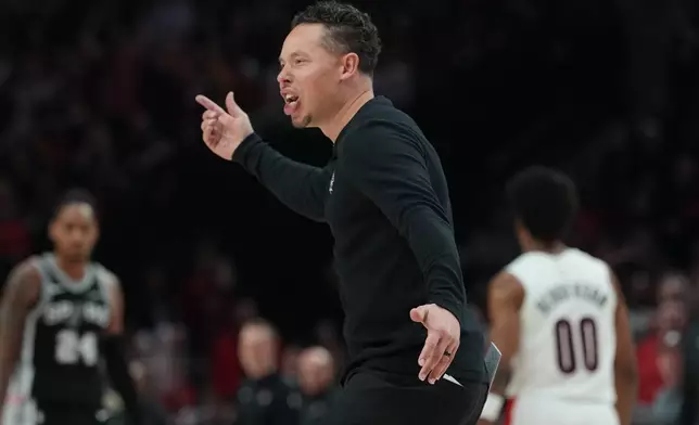 San Antonio Spurs head coach Mitch Johnson reacts to a play during the second half in Game 3 of a first-round NBA playoffs basketball series against the Portland Trail Blazers in Portland, Ore, Friday, April 24, 2026. (AP Photo/Jenny Kane)