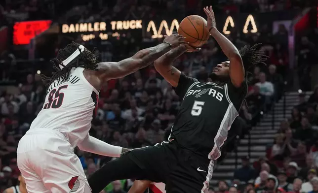 San Antonio Spurs guard Stephon Castle (5) shoots against Portland Trail Blazers center Robert Williams III (35) during the second half in Game 3 of a first-round NBA playoffs basketball series in Portland, Ore, Friday, April 24, 2026. (AP Photo/Jenny Kane)