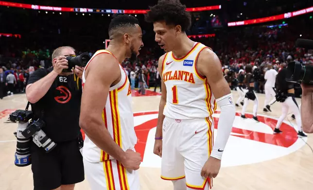 Atlanta Hawks guard CJ McCollum, left, and forward Jalen Johnson, right, react after Game 3 of a first-round NBA playoffs basketball series against the New York Knicks, Thursday, April 23, 2026, in Atlanta. (AP Photo/Colin Hubbard)