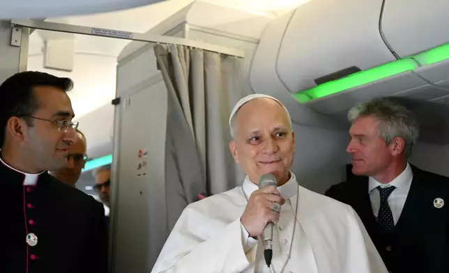 Pope Leo XIV speaks to journalists aboard his flight bound for Algiers’ Houari Boumédiène International Airport on Monday, April 13, 2026, at the start of an 11-day apostolic journey to Africa. (Alberto Pizzoli/Pool Photo via AP)
