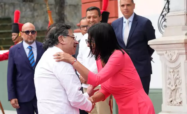 Venezuela's acting President Delcy Rodriguez, right, greets Colombian President Gustavo Petro upon his arrival at Miraflores Palace in Caracas, Venezuela, Friday, April 24, 2026. (AP Photo/Ariana Cubillos)