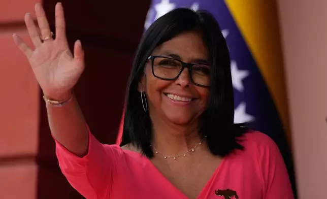 Venezuela's acting President Delcy Rodriguez waves as she waits for Colombian President Gustavo Petro at Miraflores Palace in Caracas, Venezuela, Friday, April 24, 2026. (AP Photo/Ariana Cubillos)