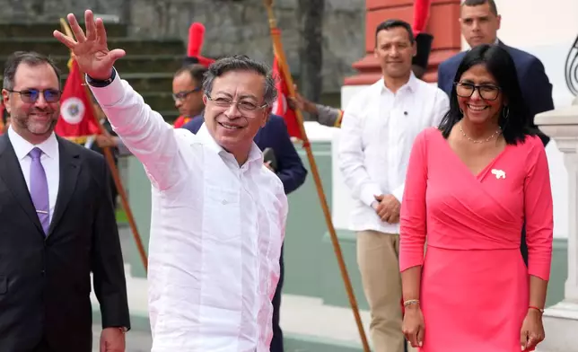 Colombian President Gustavo Petro waves after his arrival to meet Venezuela's acting President Delcy Rodriguez at Miraflores presidential palace in Caracas, Venezuela, Friday, April 24, 2026. (AP Photo/Ariana Cubillos)