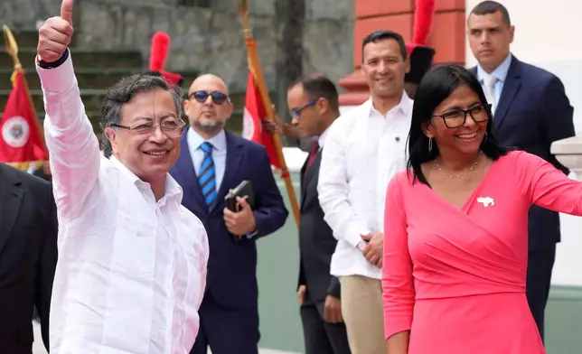 Colombian President Gustavo Petro waves upon his arrival to meet Venezuela's acting President Delcy Rodriguez at Miraflores Palace in Caracas, Venezuela, Friday, April 24, 2026. (AP Photo/Ariana Cubillos)