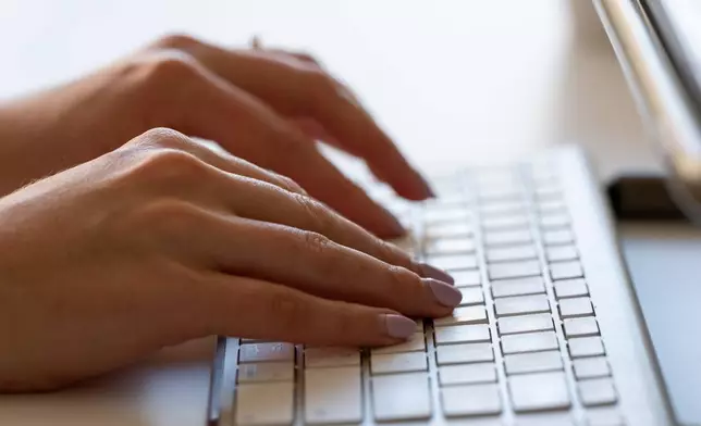 FILE - A person types on a keyboard on June 6, 2024, in Portland, Ore. (AP Photo/Jenny Kane, File)