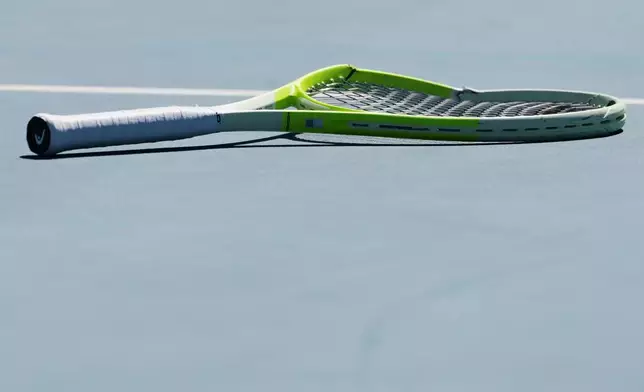 FILE - Alejandro Davidovich Fokina of Spain's racket lies on the court during his second round match against Reilly Opelka of the U.S. at the Australian Open tennis championship in Melbourne, Australia, on Jan. 21, 2026. (AP Photo/Aaron Favila)
