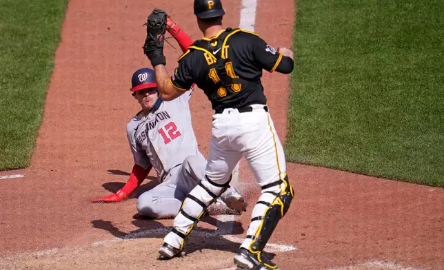 Pittsburgh Pirates catcher Joey Bart gets the force out at home plate on Washington Nationals' Brady House (12) during the ninth inning of a baseball game in Pittsburgh, Thursday, April 16, 2026. (AP Photo/Gene J. Puskar)