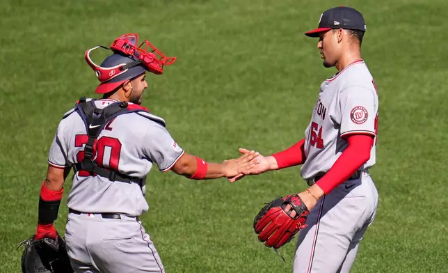 Washington Nationals pitcher Orlando Ribaita, right, celebrates with catcher Keibert Ruiz after getting the final out of a baseball game against the Pittsburgh Pirates in Pittsburgh, Thursday, April 16, 2026. (AP Photo/Gene J. Puskar)