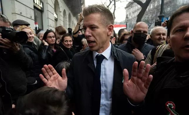 FILE - Péter Magyar, the former husband of one-time justice minister and Orbán ally Judit Varga meets with people in the crowd after his speech on Hungary's National Day in Budapest on Friday, March 15. 2024. (AP Photo/Denes Erdos, File)