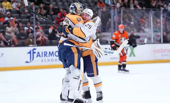 Nashville Predators' right wing Joakim Kemell (25) hugs goaltender Justus Annunen (29) after an NHL hockey game against the Anaheim Ducks, Tuesday, April 7, 2026, in Anaheim, Calif. (AP Photo/Scott Strazzante)