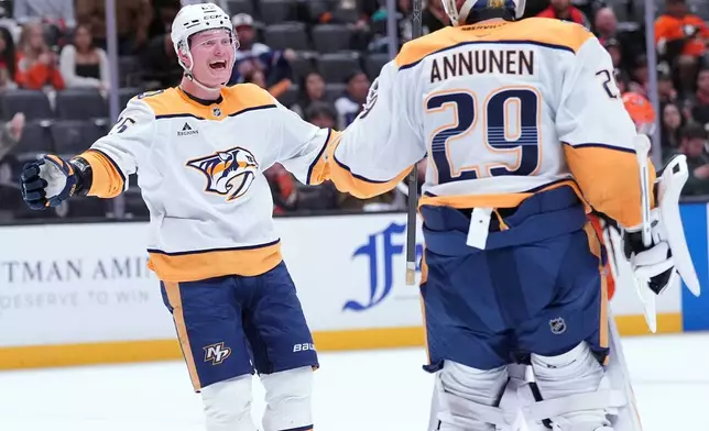 Nashville Predators' right wing Joakim Kemell (25) celebrates with goaltender Justus Annunen (29) after an NHL hockey game against the Anaheim Ducks, Tuesday, April 7, 2026, in Anaheim, Calif.. (AP Photo/Scott Strazzante)