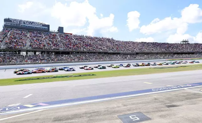 Tyler Reddick (45) and Kyle Larson (5) lead the pack to the start during a NASCAR Cup Series auto race, Sunday, April 26, 2026, in Talladega, Ala. (AP Photo/Butch Dill)