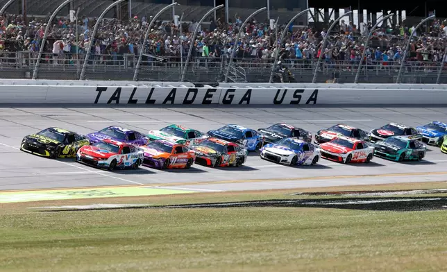 Tyler Reddick (45) and Kyle Larson (5) lead the pack to the start during a NASCAR Cup Series auto race, Sunday, April 26, 2026, in Talladega, Ala. (AP Photo/Butch Dill)