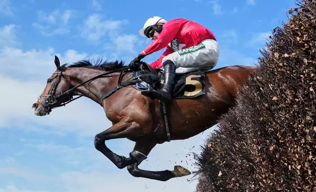 Mirabad ridden by Tristan Durrell clears a fence on the way to winning the Hallgarten &amp; Novum Wines Maghull Novices' Chase during the Grand National horse race meeting at Aintree racecourse in Liverpool, Saturday, April 11, 2026. (AP Photo/Jon Super)