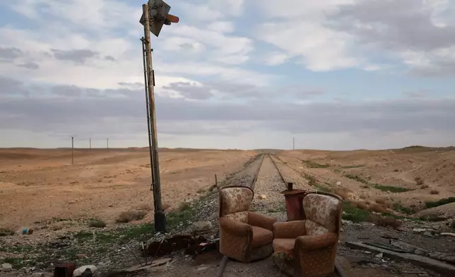Two armchairs sit at an abandoned railway crossing used as a checkpoint by the Assad regime's Syrian army, east of Homs, Syria, Saturday, April 11, 2026. (AP Photo/Ghaith Alsayed)