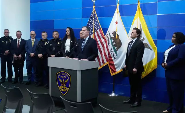 Craig Missakian, U.S. Attorney, Northern District of California, middle, speaks during a news conference Monday, April 13, 2026, in San Francisco. (AP Photo/Jeff Chiu)