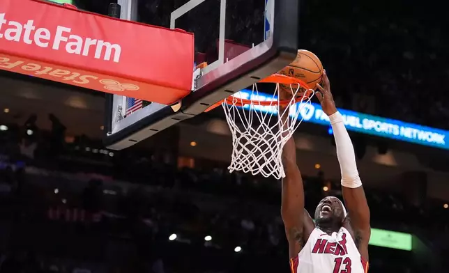Miami Heat center Bam Adebayo jumps to dunk during the second half of an NBA basketball game against the Atlanta Hawks, Sunday, April 12, 2026, in Miami. (AP Photo/Rebecca Blackwell)
