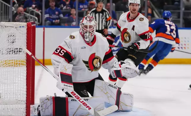 Ottawa Senators goaltender Linus Ullmark (35) and Thomas Chabot (72) protects the net during the second period of an NHL hockey game against the New York Islanders Saturday, April 11, 2026, in Elmont, N.Y. (AP Photo/Frank Franklin II)